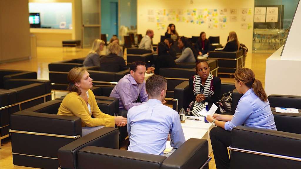 Group having conversation while sitting around table