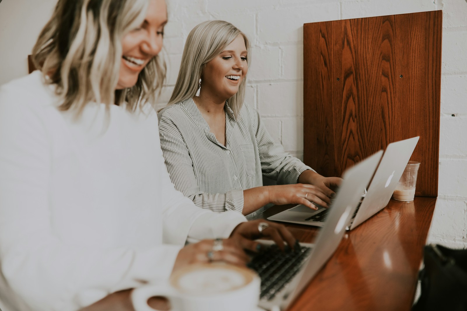 two women using laptops health, insurance, gig