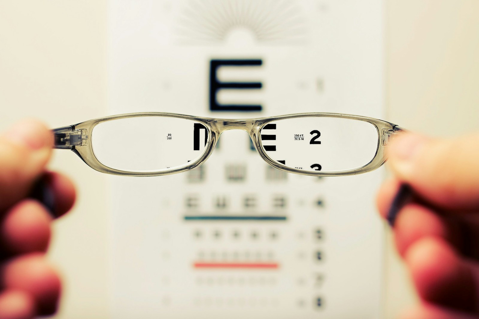 person holding eyeglasses, vision