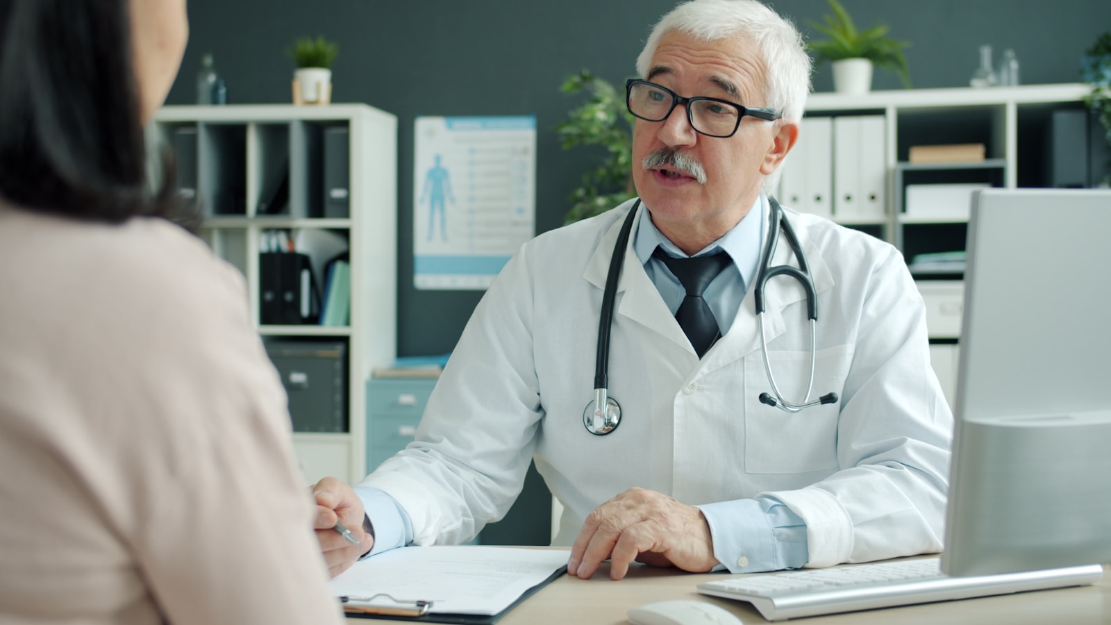 Doctor talking to patient in an office, HDHPs